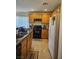 The kitchen features oak cabinets, a black oven range and white refrigerator at 1169 Paradise River Rd, Henderson, NV 89002