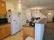 View of kitchen with access to living area featuring a white refrigerator, oak cabinets at 1169 Paradise River Rd, Henderson, NV 89002