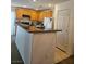 Functional kitchen featuring breakfast bar, oak cabinetry, and white appliances at 1169 Paradise River Rd, Henderson, NV 89002