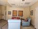 An inviting lobby area with comfortable seating and neutral decor, featuring tiled floors and ample natural light at 1169 Paradise River Rd, Henderson, NV 89002