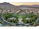 Aerial view showcasing community park, playgrounds, lush landscaping, and surrounding neighborhood at 11764 Golden Moments Ave, Las Vegas, NV 89138
