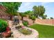 Backyard oasis features a serene rock waterfall, creating a peaceful and inviting outdoor space at 11764 Golden Moments Ave, Las Vegas, NV 89138