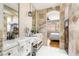 Bright bathroom features double vanity, stone accent wall, decorative fixtures, and access to bedroom at 11764 Golden Moments Ave, Las Vegas, NV 89138