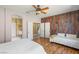 Bedroom with wood floors, connected to ensuite bathroom with double vanity and glass enclosed shower at 11764 Golden Moments Ave, Las Vegas, NV 89138