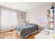 Cozy bedroom with wood-look floors, accent decor, large window, and a bright, airy feel at 11764 Golden Moments Ave, Las Vegas, NV 89138
