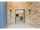 Inviting entryway featuring stone accent wall, tile flooring and seamless transition to living space at 11764 Golden Moments Ave, Las Vegas, NV 89138