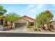 Charming single-story home with a well-manicured front yard and a two-car garage at 11764 Golden Moments Ave, Las Vegas, NV 89138