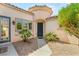 Charming front entrance with desert landscaping, curved architectural details, and a welcoming walkway at 11764 Golden Moments Ave, Las Vegas, NV 89138