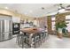 Bright kitchen with a large wood island, stainless steel appliances, and stone accent wall at 11764 Golden Moments Ave, Las Vegas, NV 89138