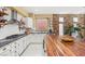 Spacious kitchen boasts granite countertops, white cabinetry, and a butcher block island at 11764 Golden Moments Ave, Las Vegas, NV 89138