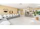 Open-concept living room featuring a large gray couch and island with bar seating at 11764 Golden Moments Ave, Las Vegas, NV 89138