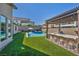 Spacious backyard featuring a pool, spa, outdoor kitchen and covered patio area for entertaining at 11954 Camden Ridge Ct, Las Vegas, NV 89138