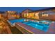 Backyard showcasing a pool, spa, pergola with outdoor kitchen, and inviting evening ambiance at 11954 Camden Ridge Ct, Las Vegas, NV 89138