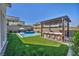 Backyard features a built-in bar, outdoor seating and cooking area adjacent to a refreshing pool and spa at 11954 Camden Ridge Ct, Las Vegas, NV 89138