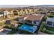 Aerial view of a backyard featuring a pool with an integrated spa, covered outdoor kitchen, and manicured landscaping at 11954 Camden Ridge Ct, Las Vegas, NV 89138
