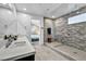 Contemporary bathroom with dual sinks, sleek white counters, and glass enclosed shower at 11954 Camden Ridge Ct, Las Vegas, NV 89138