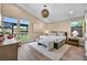 Cozy bedroom with vaulted ceiling, neutral tones, and view of outdoor kitchen at 11954 Camden Ridge Ct, Las Vegas, NV 89138