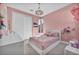 Charming pink bedroom with a comfortable bed, stylish lighting, and decorative accents at 11954 Camden Ridge Ct, Las Vegas, NV 89138