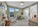 Cozy bedroom with a crib, comfy seating, and natural light creating a peaceful environment at 11954 Camden Ridge Ct, Las Vegas, NV 89138