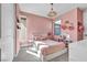 Bright bedroom showcases a bed, modern chandelier, and natural light from the window, creating an inviting space at 11954 Camden Ridge Ct, Las Vegas, NV 89138