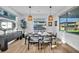 Bright dining room with modern table setting and outdoor view of backyard and outdoor kitchen at 11954 Camden Ridge Ct, Las Vegas, NV 89138