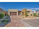 Contemporary single-story home showcasing desert landscaping, brick driveway, and neutral color palette at 11954 Camden Ridge Ct, Las Vegas, NV 89138
