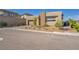 Modern home exterior with stone accents, desert landscaping, and a two-car garage at 11954 Camden Ridge Ct, Las Vegas, NV 89138