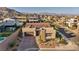 Aerial view of desert home with brick driveway, tile roof and mountain views at 11954 Camden Ridge Ct, Las Vegas, NV 89138