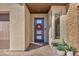 Stylish front entrance with a blue door, stone accents, and potted plants enhancing curb appeal at 11954 Camden Ridge Ct, Las Vegas, NV 89138