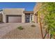 Charming single-story home with desert landscaping, modern architectural elements, and a two car garage at 11954 Camden Ridge Ct, Las Vegas, NV 89138