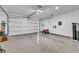 Spacious garage features epoxy flooring, an overhead garage door, and ample space for parking at 11954 Camden Ridge Ct, Las Vegas, NV 89138
