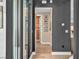 Hallway showcases modern design with dark gray walls, light wood flooring, and tastefully framed wall art at 11954 Camden Ridge Ct, Las Vegas, NV 89138