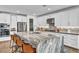 Modern kitchen featuring a large island with bar seating, stainless steel appliances, and ample storage at 11954 Camden Ridge Ct, Las Vegas, NV 89138