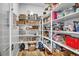 Organized pantry with white shelving stocked with food items, baskets, and a red toaster at 11954 Camden Ridge Ct, Las Vegas, NV 89138