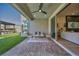 Covered patio area with stylish seating, a ceiling fan, and access to the home's interior at 11954 Camden Ridge Ct, Las Vegas, NV 89138