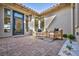 Charming patio with brick flooring, comfortable seating, and stylish decor for outdoor relaxation at 11954 Camden Ridge Ct, Las Vegas, NV 89138