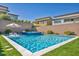 Backyard pool and spa with lush artificial turf, surrounded by modern homes and privacy walls at 11954 Camden Ridge Ct, Las Vegas, NV 89138