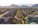 Community walking path winding through desert landscaping with views of neighboring homes and distant mountains at 11954 Camden Ridge Ct, Las Vegas, NV 89138
