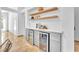 Open bar area boasts custom cabinets, floating shelves, and two beverage coolers for the ultimate in-home entertaining experience at 1212 Anime Dr, Las Vegas, NV 89144