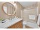 Well-lit bathroom featuring a marble countertop, a decorative mirror, and a shower with sliding glass doors at 1212 Anime Dr, Las Vegas, NV 89144