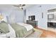 This main bedroom features hardwood floors, an en suite bathroom, a ceiling fan, and a neutral color palette at 1212 Anime Dr, Las Vegas, NV 89144