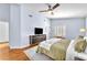 A view of the main bedroom featuring hardwood floors, a ceiling fan, a large TV, and a neutral color palette at 1212 Anime Dr, Las Vegas, NV 89144