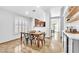 Elegant dining area featuring a wooden table, contemporary chairs, shutters, and stylish decor at 1212 Anime Dr, Las Vegas, NV 89144