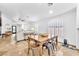 Open-concept dining area with a wooden table, modern chairs, and an open view to the living room at 1212 Anime Dr, Las Vegas, NV 89144