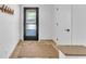 Bright entryway with a decorative rug, and coat rack, adjacent to a white door and stylish flooring at 1212 Anime Dr, Las Vegas, NV 89144