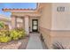Inviting front porch with desert landscaping, neutral color palette, and decorative columns at the entrance at 1212 Anime Dr, Las Vegas, NV 89144