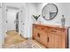 Inviting foyer featuring a wooden console table, stylish decor, and a round mirror at 1212 Anime Dr, Las Vegas, NV 89144