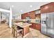 Spacious kitchen features an island with seating, stainless steel appliances, and granite counters at 1212 Anime Dr, Las Vegas, NV 89144