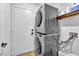 Efficient laundry space equipped with a stacked washer and dryer to maximize space at 1212 Anime Dr, Las Vegas, NV 89144