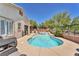 Private backyard features a sparkling pool, a tranquil waterfall, and comfortable lounge furniture at 1212 Anime Dr, Las Vegas, NV 89144